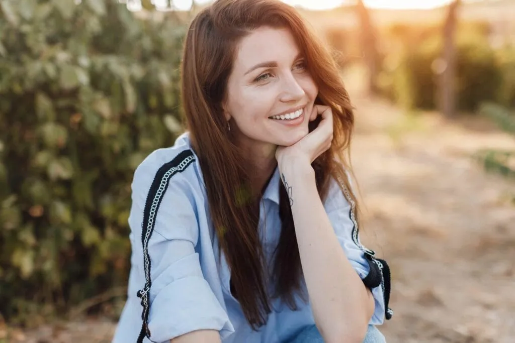 Woman smiling outdoors.