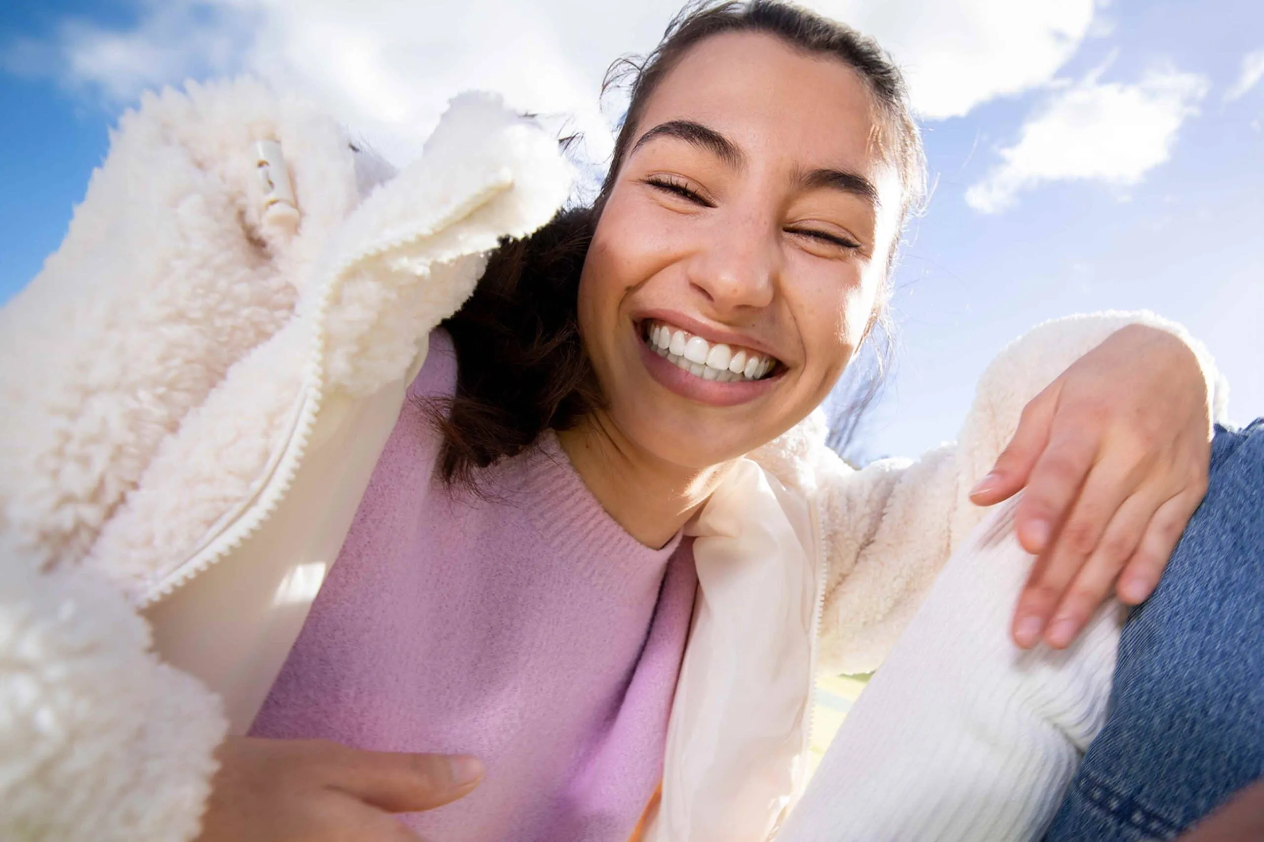 Teenage girl smiling after whitening treatment.